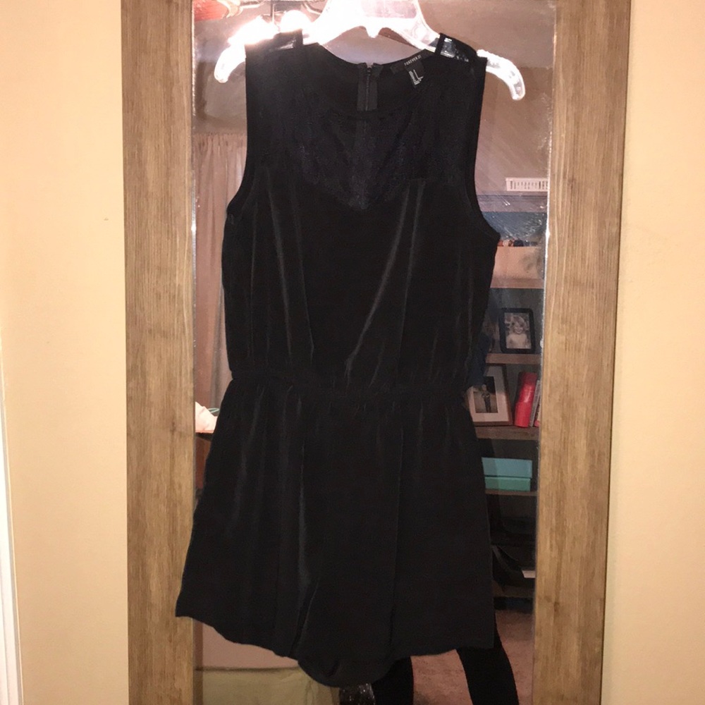 Black romper with lace detail! Zips up the back.